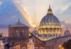 Vatican On Edge: Pope Heads To OR St. Peter's Basilica dome at sunset with glowing sky