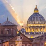 Vatican On Edge: Pope Heads To OR St. Peter's Basilica dome at sunset with glowing sky