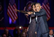 Michelle Obama and Rob Nabors pointing on stage at an event