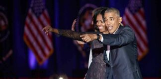 Michelle Obama and Rob Nabors pointing on stage at an event
