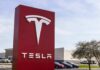 Livestream Hype, Five Figures Down Tesla dealership sign in front of parking lot