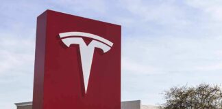 Tesla dealership sign in front of parking lot