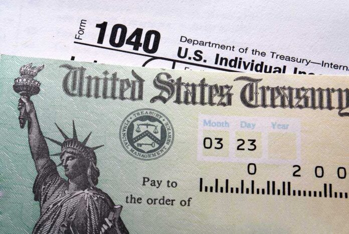 Tax,Return,Check,On,1040,Form,Background Close-up of a U.S. Treasury check and tax form 1040